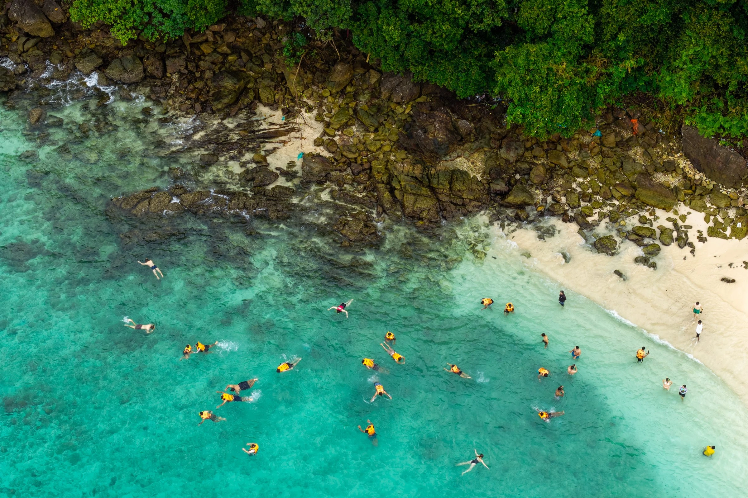 Employees competing in a beach snorkelling activity during a Phuket company retreat